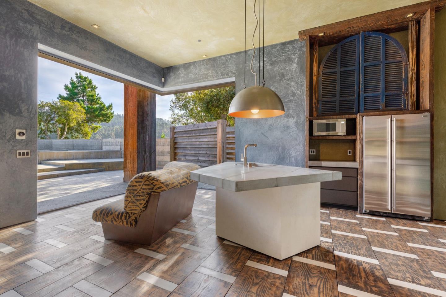 566 Aguajito Road Carmel, CA 93923 - Photo 47 of 78 a living room with couches and a dining table with outer view