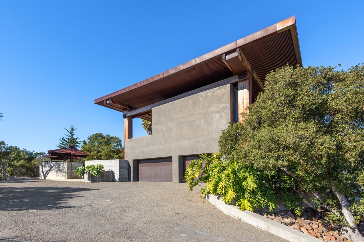566 Aguajito Road Carmel, CA 93923 - Photo 67 of 78 a front view of a house with a yard and garage
