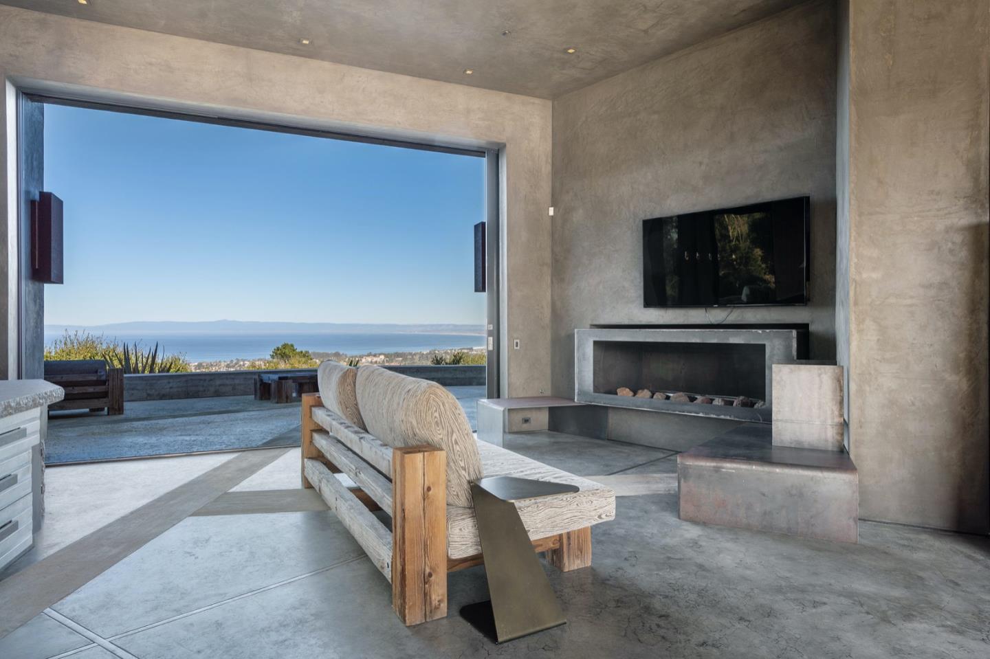 566 Aguajito Road Carmel, CA 93923 - Photo 9 of 78 a living room with furniture and a fireplace