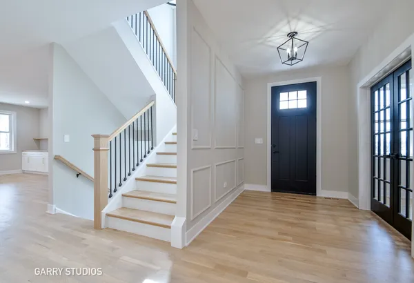 a view of entryway with stairs and wooden floor