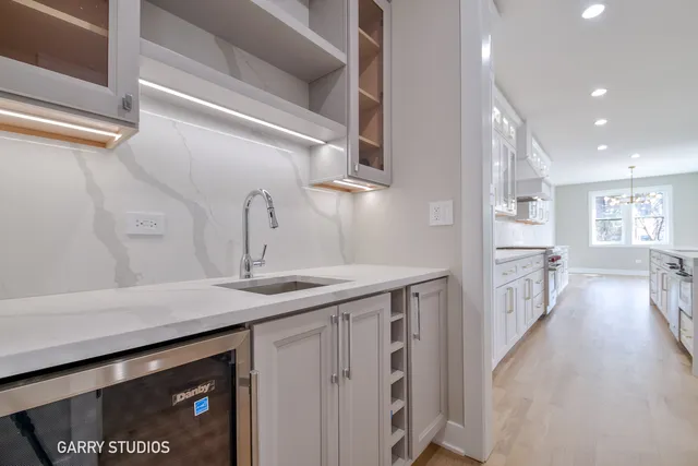 a kitchen with a sink stove and cabinets