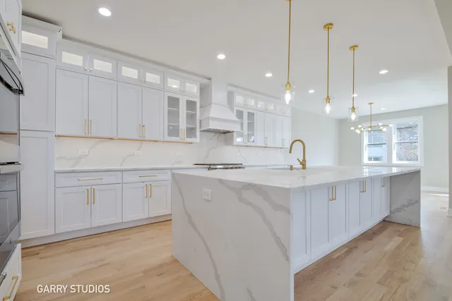 a kitchen with white cabinets appliances and a sink