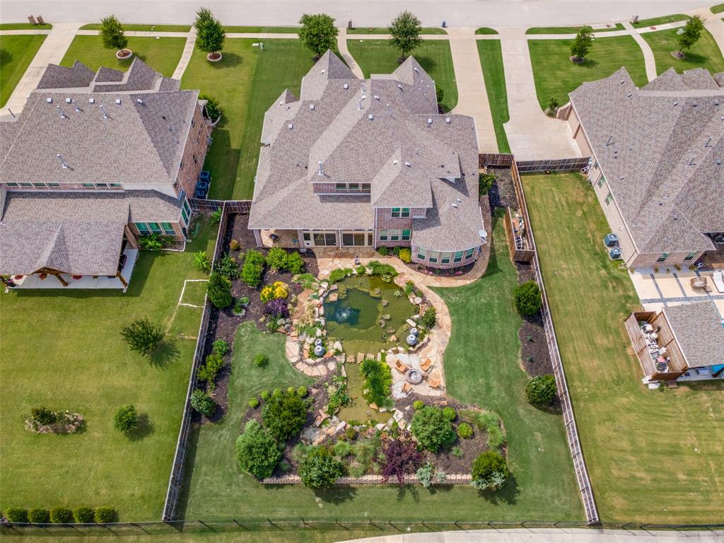 388 Bethany Road Sunnyvale, TX 75182 - Photo 40 of 40 Expansive backyard featuring a natural swimming pond with water features, mature landscaping, and a manicured lawn