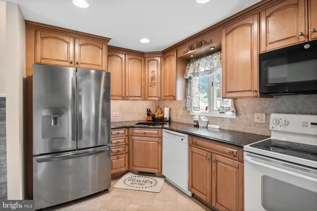 a kitchen with a sink stove and microwave