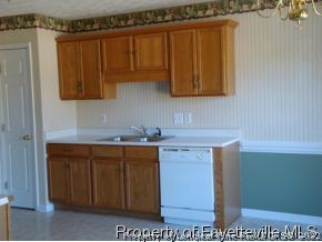 203 Kernstown Road Raeford, NC 28376 - Photo 5 of 12 a kitchen with a sink a cabinets and window
