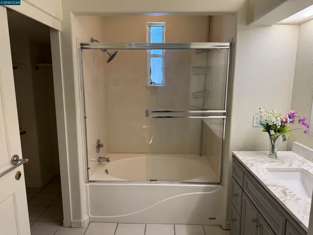 a bathroom with a tub and a shower