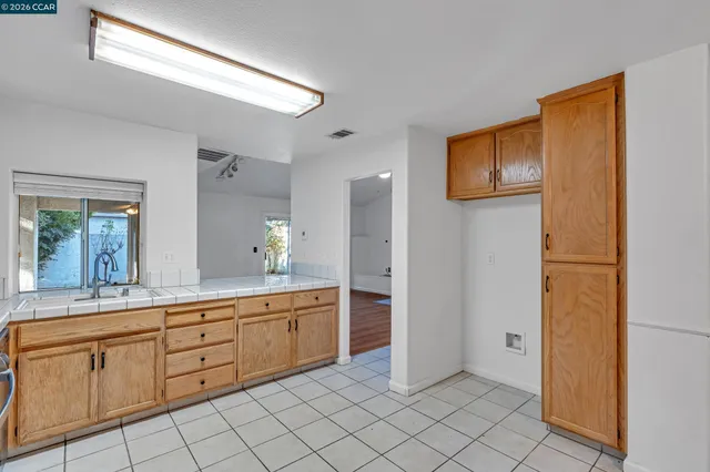 a kitchen with a refrigerator and a stove top oven