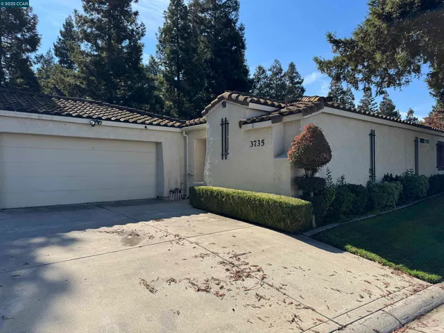 a front view of a house with garden and patio