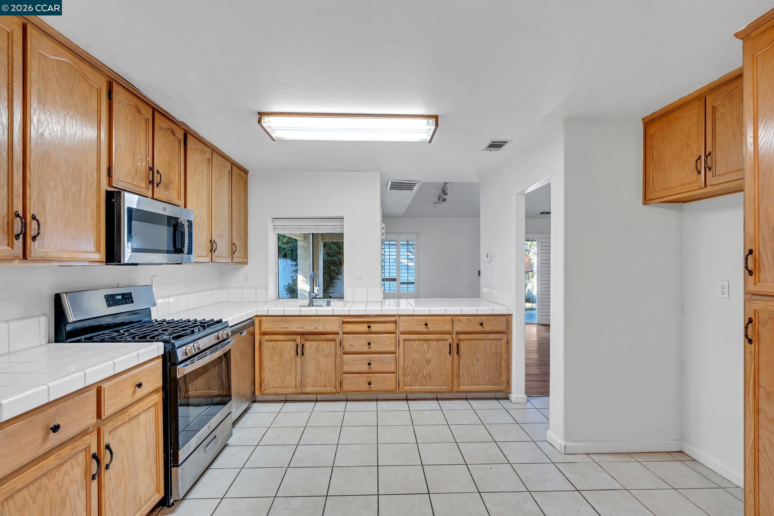 3735 Ignacio Circle Stockton, CA 95209 - Photo 22 of 22 a kitchen with stainless steel appliances granite countertop a sink and cabinets