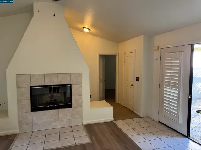 a living room with a fireplace and a rug