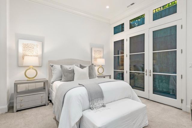 a spacious bedroom with a couch and a walk in closet