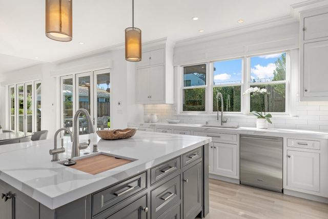 a kitchen with a sink and stove