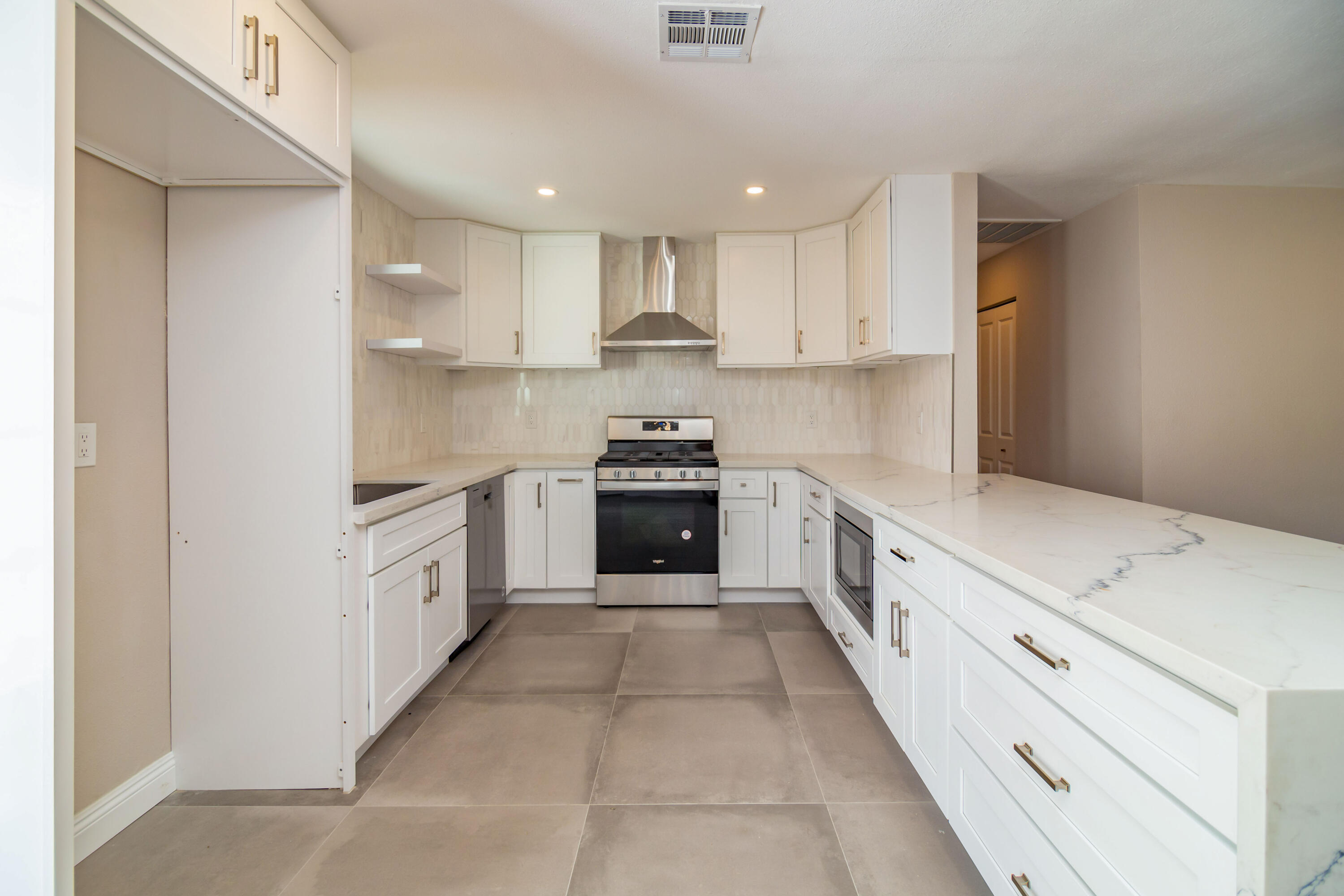 52880 Avenida Navarro La Quinta, CA 92253 - Photo 13 of 27 a large kitchen with cabinets and stainless steel appliances
