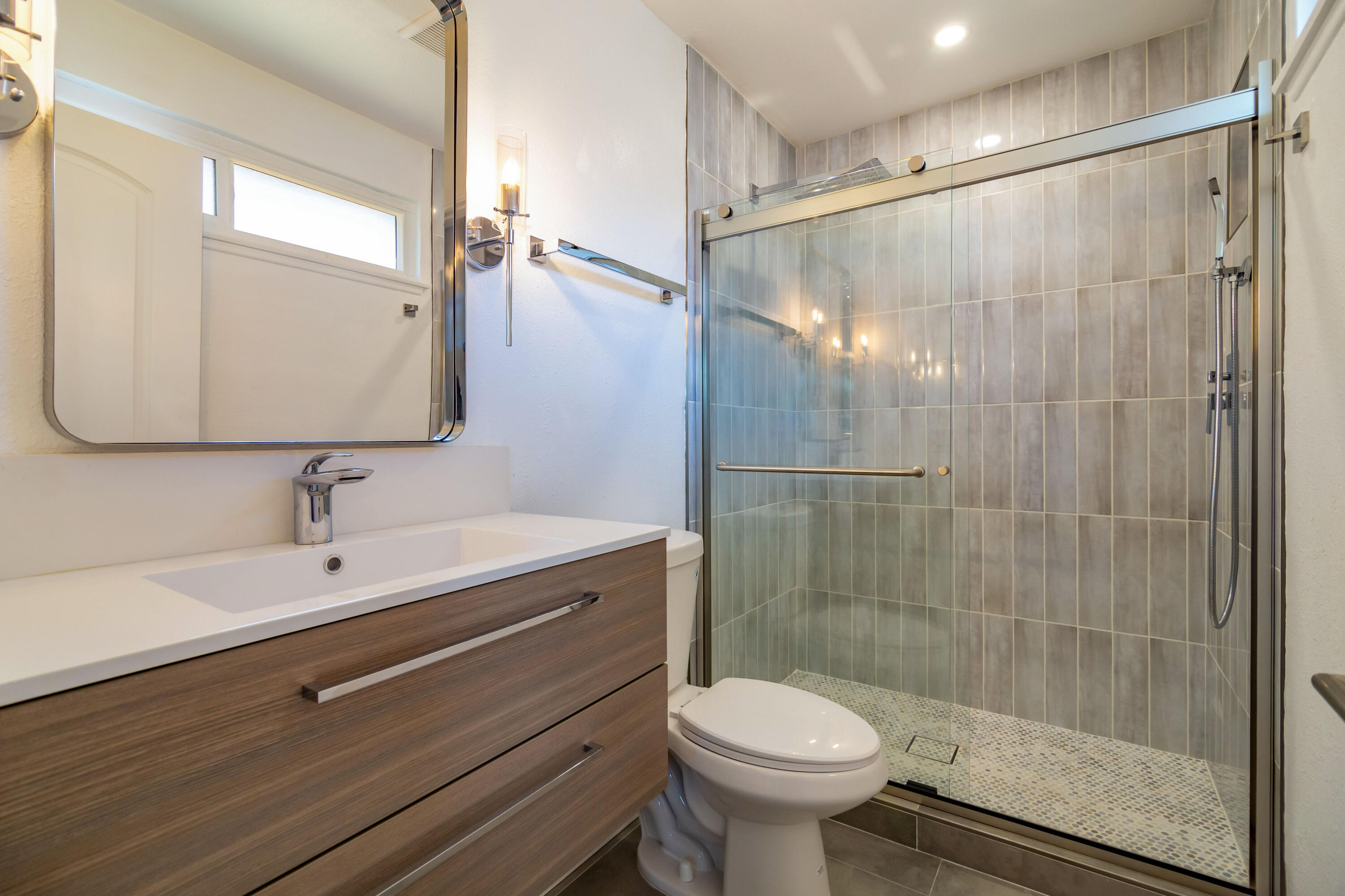 52880 Avenida Navarro La Quinta, CA 92253 - Photo 21 of 27 a bathroom with a shower a sink a toilet and a mirror