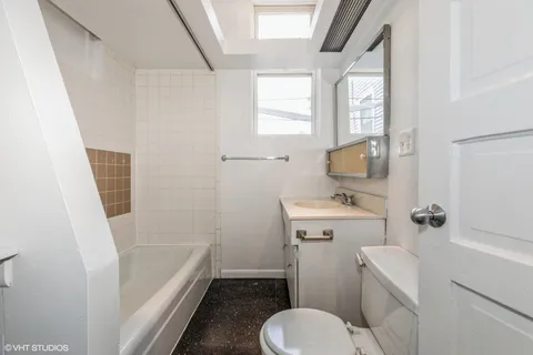 a bathroom with a sink toilet and tub