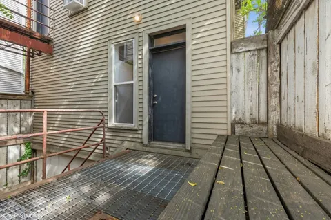 a view of a house with a door and wooden floor