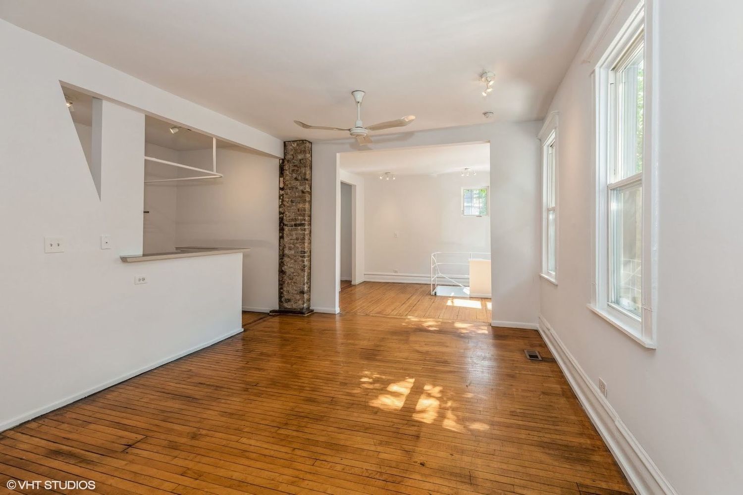 626 West 18th Street, Unit RH1 Chicago, IL 60616 - Photo 4 of 13 a view of an empty room with wooden floor and a window