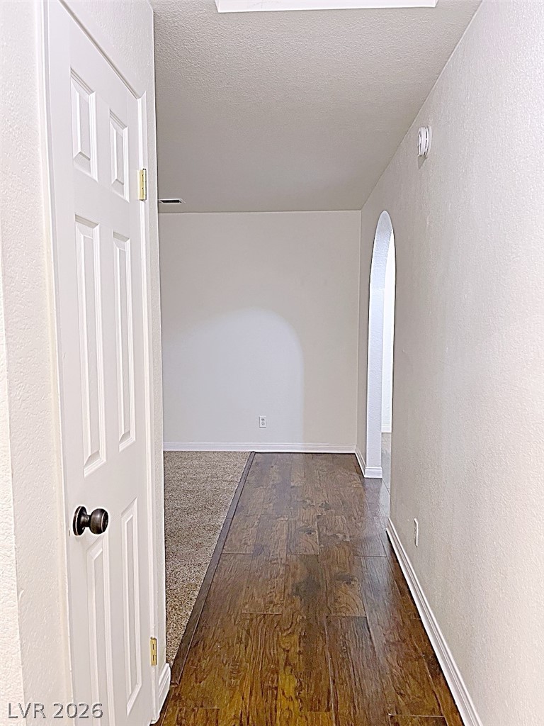 2200 South Fort Apache Road, Unit 2201 Las Vegas, NV 89117 - Photo 14 of 33 This spacious hallway features rich hardwood flooring leading to an inviting archway.