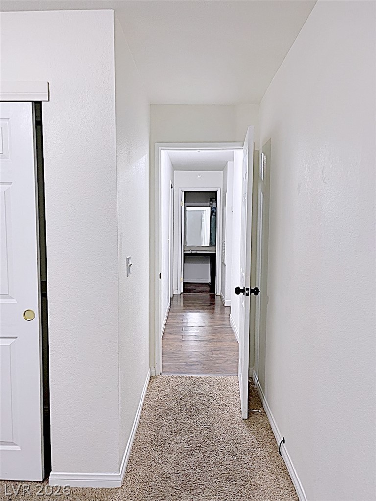 2200 South Fort Apache Road, Unit 2201 Las Vegas, NV 89117 - Photo 26 of 33 This home features a central hallway with carpet transitioning to hardwood flooring.