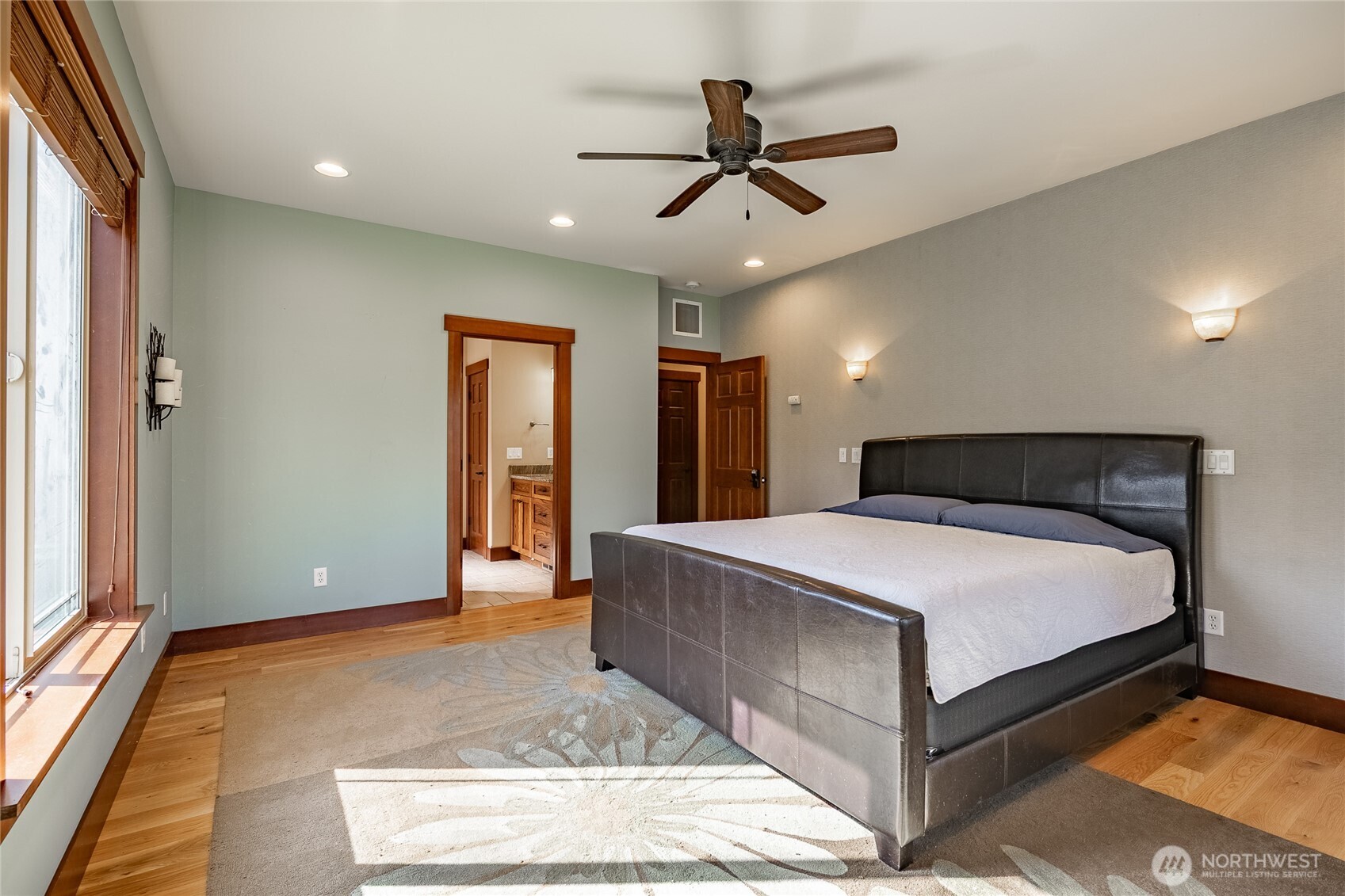 8138 Percie Road Custer, WA 98240 - Photo 20 of 40 a spacious bedroom with a bed and a chandelier