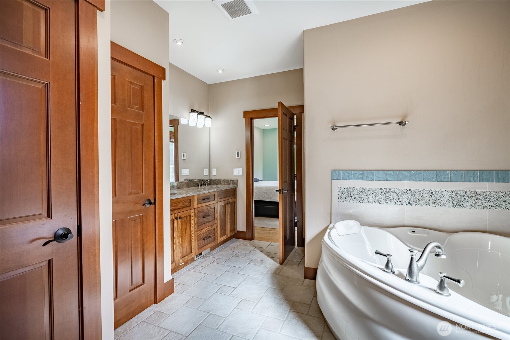 8138 Percie Road Custer, WA 98240 - Photo 21 of 40 a bathroom with a tub a sink and a large mirror