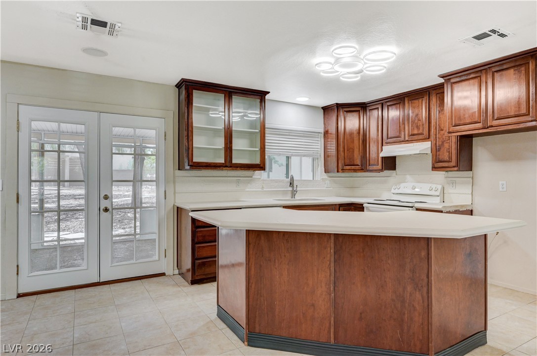 7631 Bermuda Road Las Vegas, NV 89123 - Photo 18 of 64 A well-appointed kitchen features rich wood cabinetry and ample counter space.