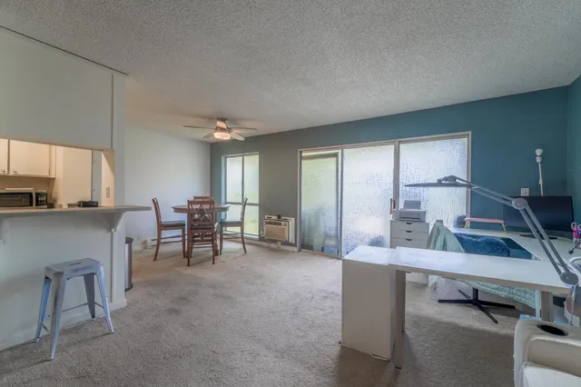 a view of a livingroom with furniture and a flat screen tv