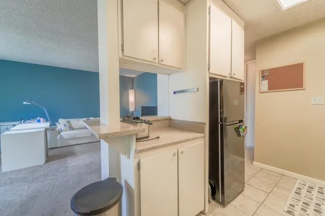 a bathroom with a granite countertop sink a mirror and a shower