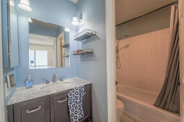 a bedroom with a bed and a chair