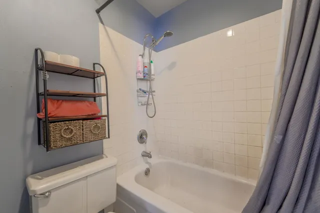 a bedroom with bed and a large mirror