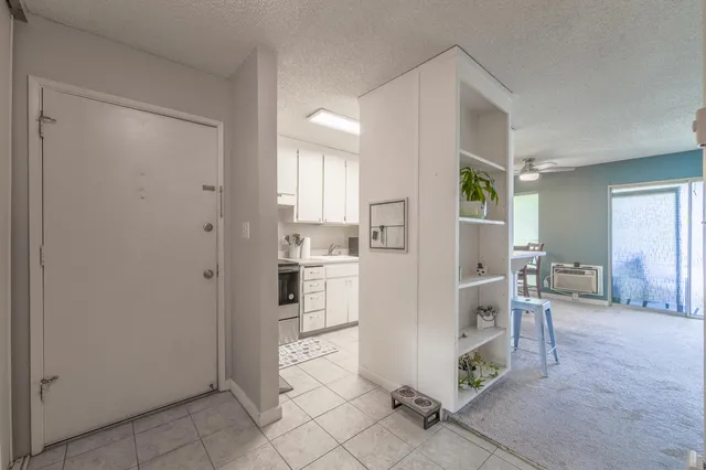 a living room with furniture a flat screen tv and a large window