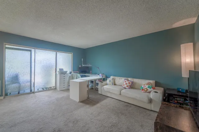a view of a dining room with furniture and a chandelier