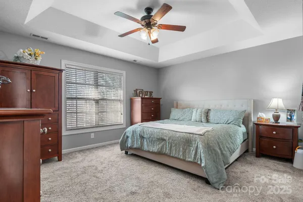 a living room with a bed furniture and a window