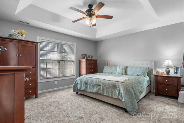 a living room with a bed furniture and a window