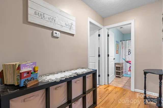 a view of a hallway to a livingroom with furniture