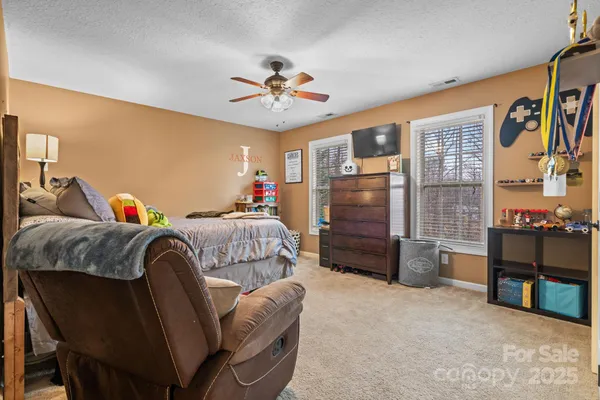 a bedroom with furniture and a flat screen tv