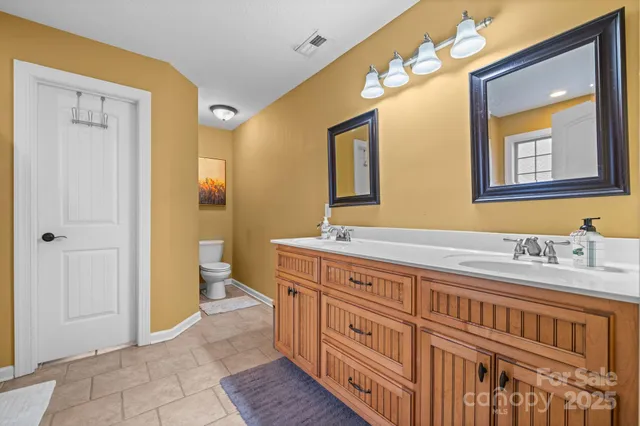 a spacious bathroom with a granite countertop sink and a mirror