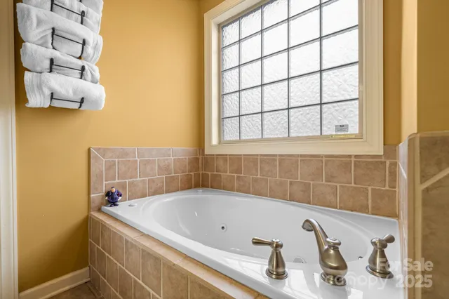 a bathroom with a tub and a window