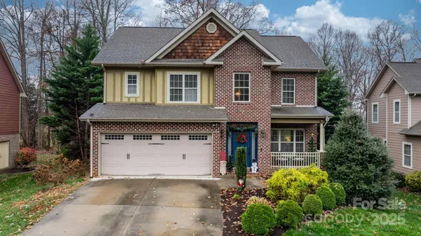 a front view of a house with a garden and plants