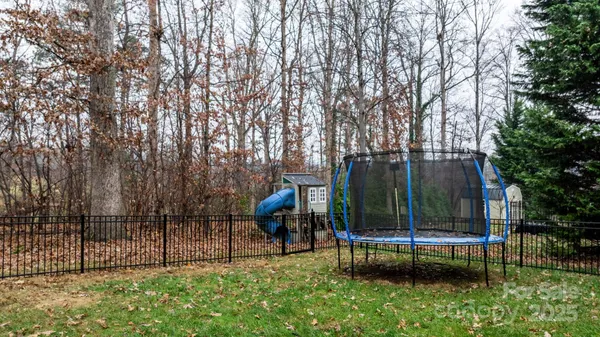 a view of a backyard with a garden and deck