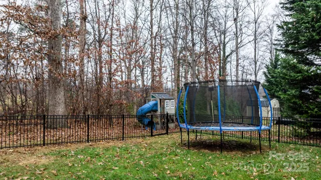 a view of a backyard with a garden and deck