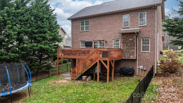 a view of house with a yard and entertaining space