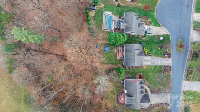 an aerial view of a house with outdoor space and street view