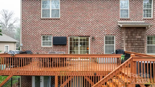 a view of a house with wooden deck