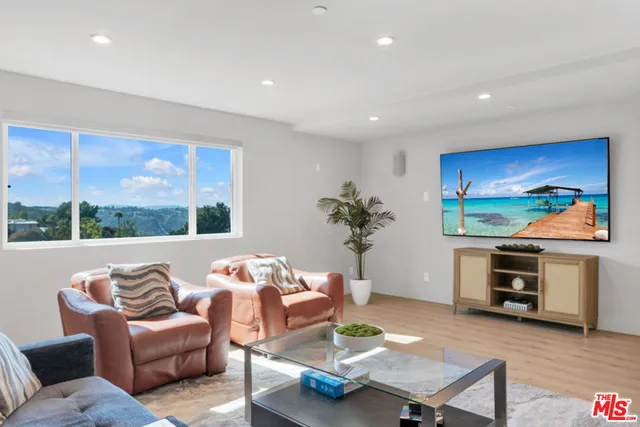 a spacious bedroom with a bed and a dresser