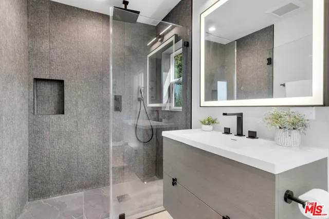 a bedroom with two beds and a night stand