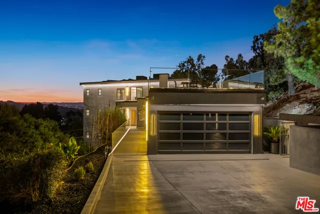 a living room with furniture a flat screen tv and a floor to ceiling window