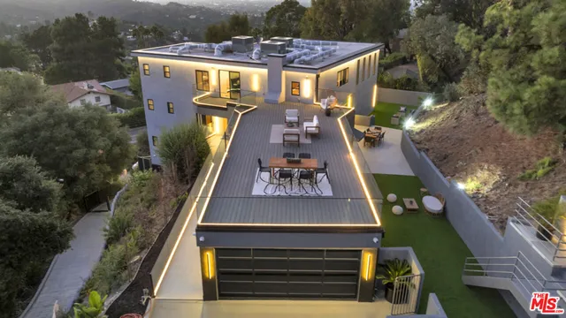 a living room with furniture a rug and a flat screen tv