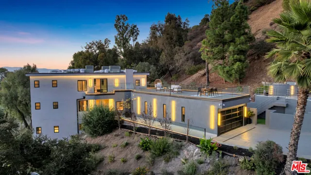 a large kitchen with kitchen island white cabinets and stainless steel appliances