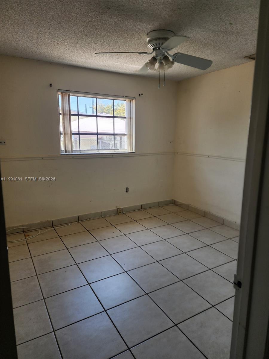 120 Southwest 80th Avenue Miami, FL 33144 - Photo 5 of 10 a view of a livingroom with an empty space and a window